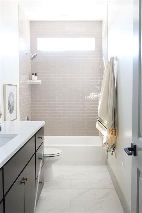 Subway tile remains focused on our mission to serve our clients as a navigator and guide to achieve their unique aesthetic vision. White staggered marble floor tiles lead to a drop-in ...