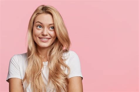 Portrait Of Pretty Young Blonde Woman Has Dreamy Cheerful Expression