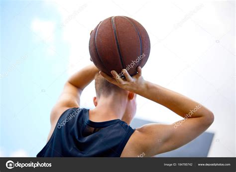 Man Holding Ball While Playing Basketball Outdoor Stock Photo By
