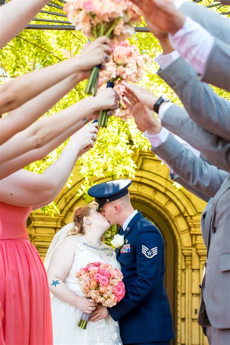 This Summer Bride And Groom Share A Kiss While Their Wedding Party