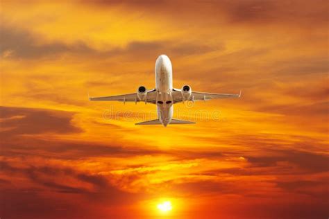 Airplane Take Off In The Bright Orange Sunset Sky Stock Image Image