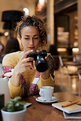 Woman Photographer During A Break In A Cafe Del Colaborador De Stocksy Mauro Grigollo En