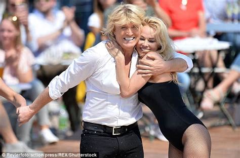 Pamela Anderson Wears Skimpy Swimsuit As She Assists Hans Klok Daily