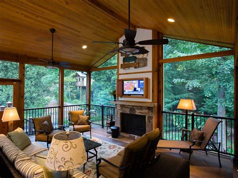 A Rustic Covered Porch With A Fireplace And Tv Screen Centerpiece