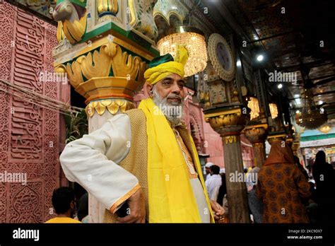 A Devout Is Seen At The Nizamuddin Dargah Embraced In Yellow On The