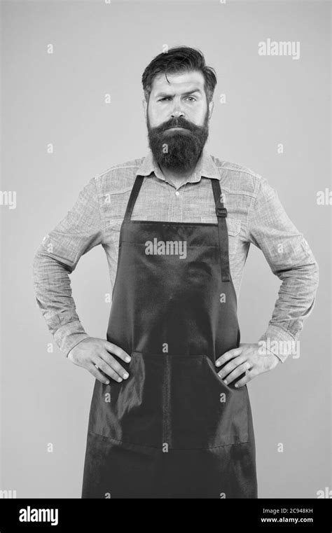 Bearded Chef Or Waiter Wearing Red Apron Brutal Waiter Or Barista Barber Man In An Apron With