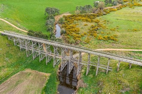 Image Of Aerial View Of A Long Wooden Trestle Bridge Across A Green