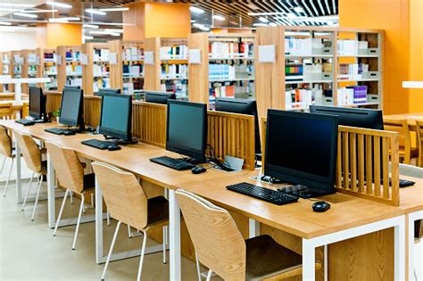 Computer And Bookshelves In Modern Library Stock Photo Download Image