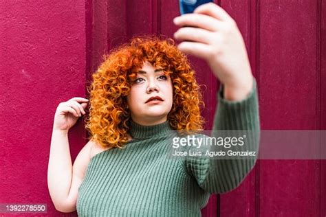 A Chubby Redhead Girl Taking A Photo With Her Cell Phone Portrait Of A
