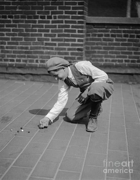 Boy 10 12 Years Playing With Marbles By Bettmann