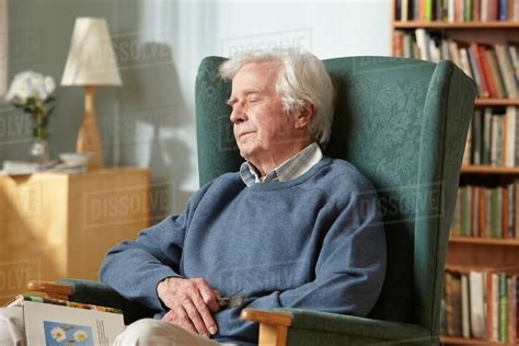 Senior Man Sleeping In Armchair Stock Photo Dissolve