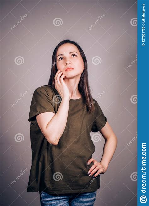 Thoughtful Young Brunette Woman Looking Up Planning Something In
