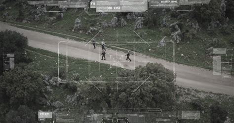 Surveillance drone camera view of terrorist squad walking with weapons ...