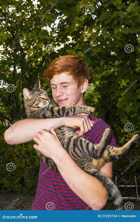 Teen Boy And His Tabby Cat Outside In The Garden Stock Photo Image Of