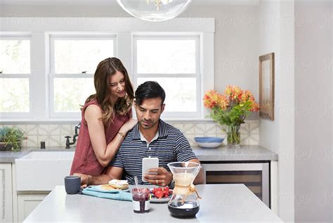 Young Couple Having Breakfast Together At Home In The Morning While