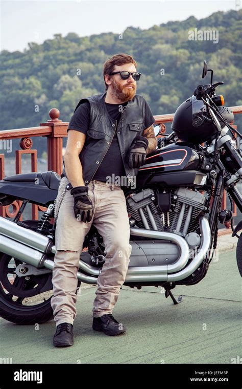 Bearded Redhead Biker With Beard In Leather Jacket Near Bike Stock