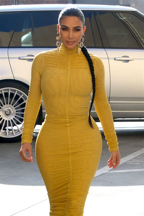kim kardashian puts her curves on display in very tight yellow dress