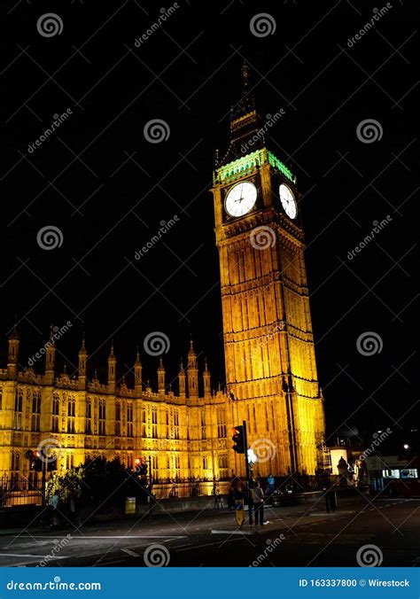 Vertical Shot Of The Illuminated Big Ben At Night With Total Black