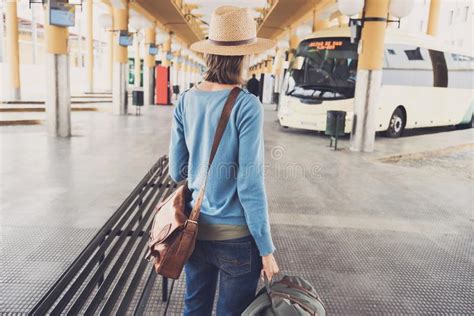 Young Woman Traveler Waiting For A Bus On A Bus Station, Travel And ...