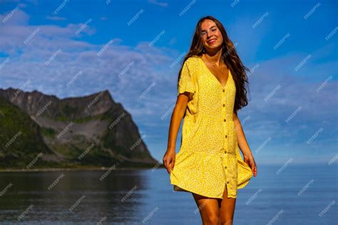 Premium Photo A Beautiful Girl In A Yellow Dress Dances On A Beach