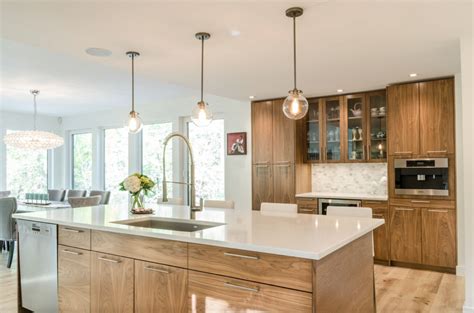 Walnut Cabinetry With Quartz Countertops And Marble Backsplash