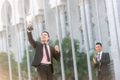 Winner Man Wins An Award With Team Members Support Behind Stock Image