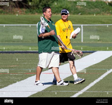 Two Rival High School Lacrosse Coaches Walking Across The Field After The Game Both Are Smiling