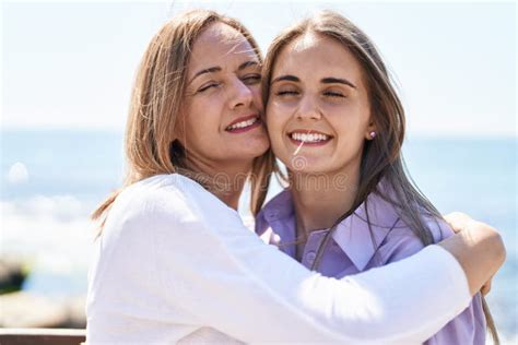 Two Women Mother And Daughter Hugging Each Other At Seaside Stock Image
