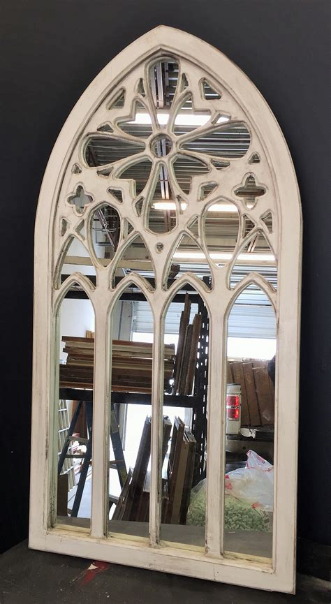 An Arched Window Is Shown With Many Pieces Of Furniture Behind It In