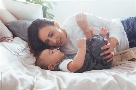 Mother Cuddling Her Baby By Stocksy Contributor Lumina Stocksy