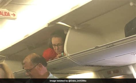 Flight Attendant In Overhead Compartment Shocks Passengers