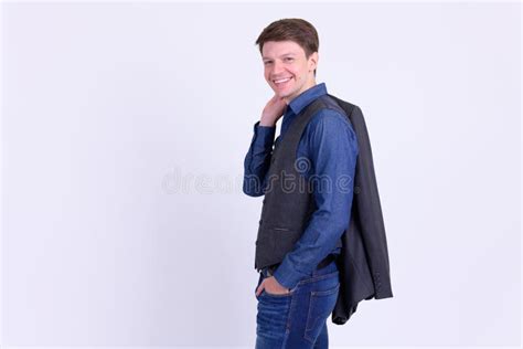 Happy Young Handsome Businessman In Suit Carrying Jacket Over Shoulder