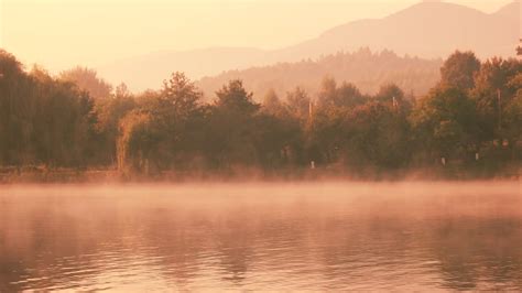 Panoramic View From Misty Lake In The Early Morning Morning Mist Over