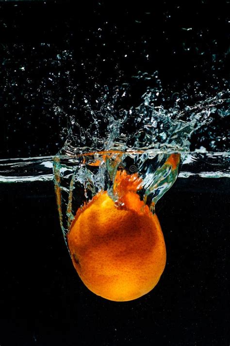 High Speed Photography Of Orange With Splash In Water Stock Image