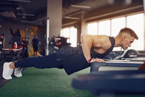 Young Athletic Man Doing Push Ups In Gym Muscular And Strong Guy