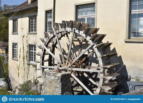 Old Wooden Water Wheel Mill Beside House At The Rhine Falls In