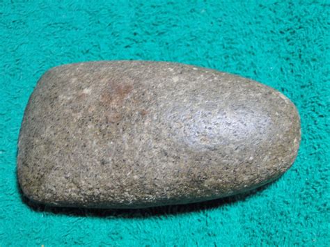 A Rock Sitting On Top Of A Green Carpet