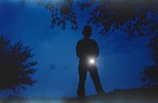 flashlight holding boy silhouette