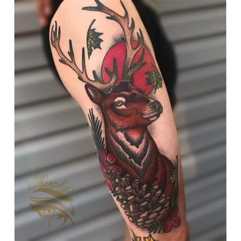 A Deer With Antlers And Pine Cones On Its Head Is Shown In This Tattoo