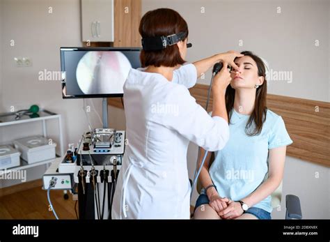 Female Otolaryngologist And Patient In Office Exam Nose Examination