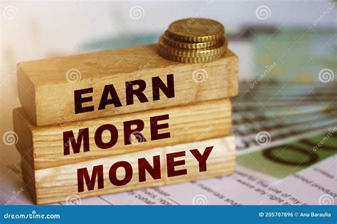 Earn More Money Written on a Wooden Blocks, Coins and Bills. Business