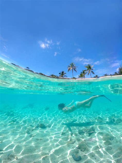 Half Underwater Girl In Turquoise Bikini Snorkels Past Beautiful Sandy