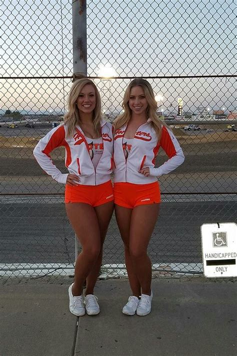 Two Hooter Girls Are Wearing Their Uniforms With Tan Pantyhose And White Tennis Shoes Hooters