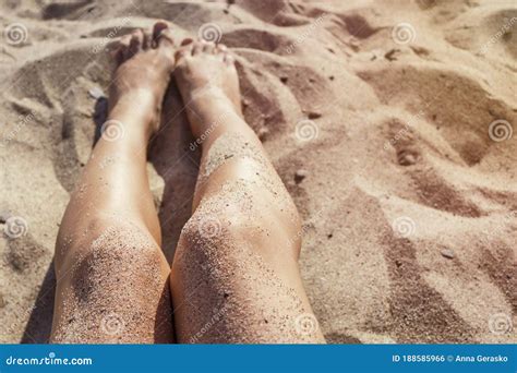 Woman Legs On A Sand Beach Toned Summer Holiday Concept Stock Photo