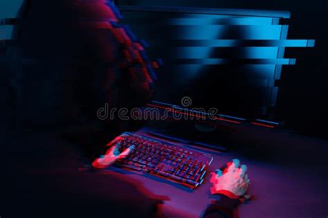 Hacker In The Hood Working With Computer Typing Text In Dark Room