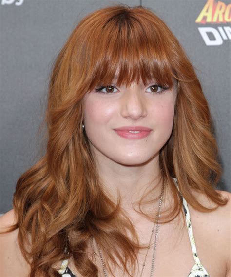 The appearance of the woman is her business enterprise card in many circumstances of lifestyle. Bella Thorne Long Wavy Copper Red Hairstyle with Layered Bangs