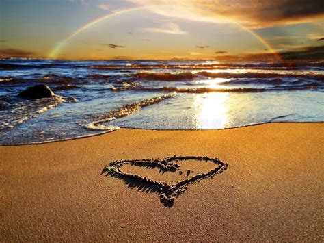 Rainbow At Sunset Sea And Heart Symbol On Sand Romantic Nature