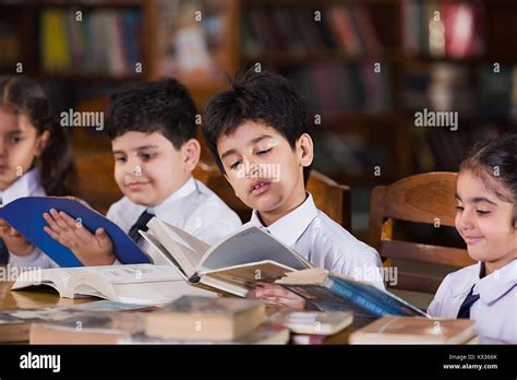 Indian School Children Students Reading Book Study In Library Stock