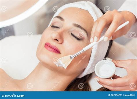 Close Up Of A Beautiful Woman Relaxing During Facial Treatment I Stock