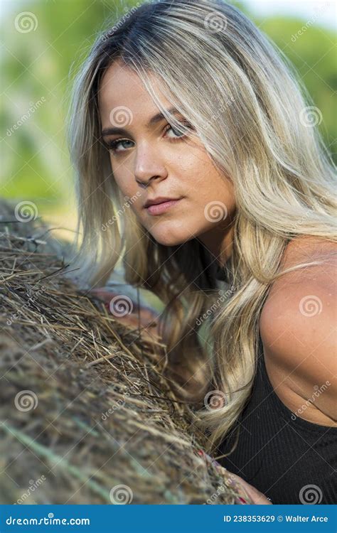 a lovely blonde model poses outdoors in a farm environment stock image image of carefree